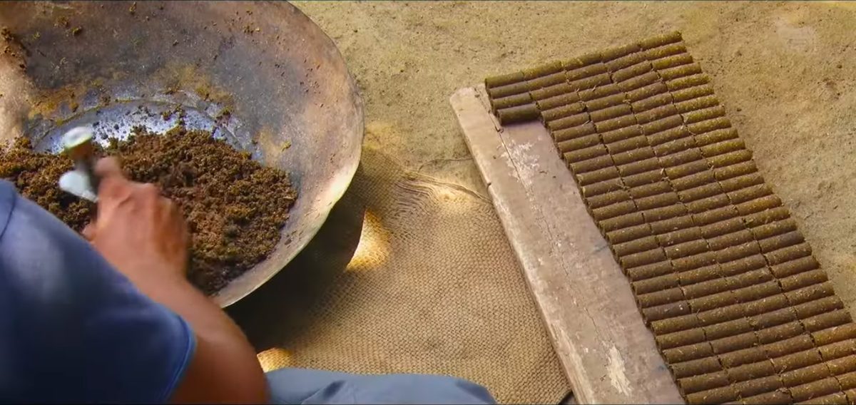 Rows of hand-rolled dhoop sticks laid out to dry naturally in the sun
